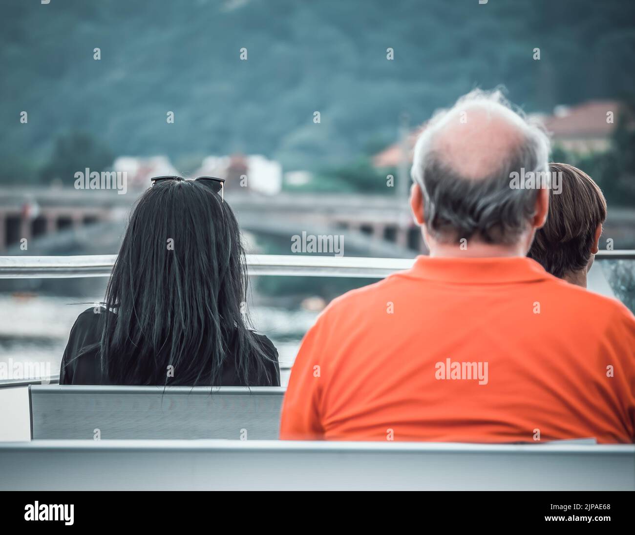 Back view picture with three people sitting down Stock Photo Alamy