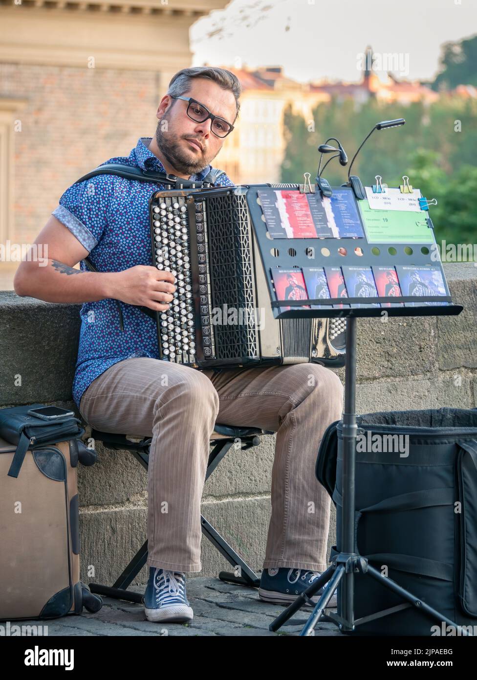 Prague, Czech Republic June 2022 Street artist musician playing at an Accordion on Charles