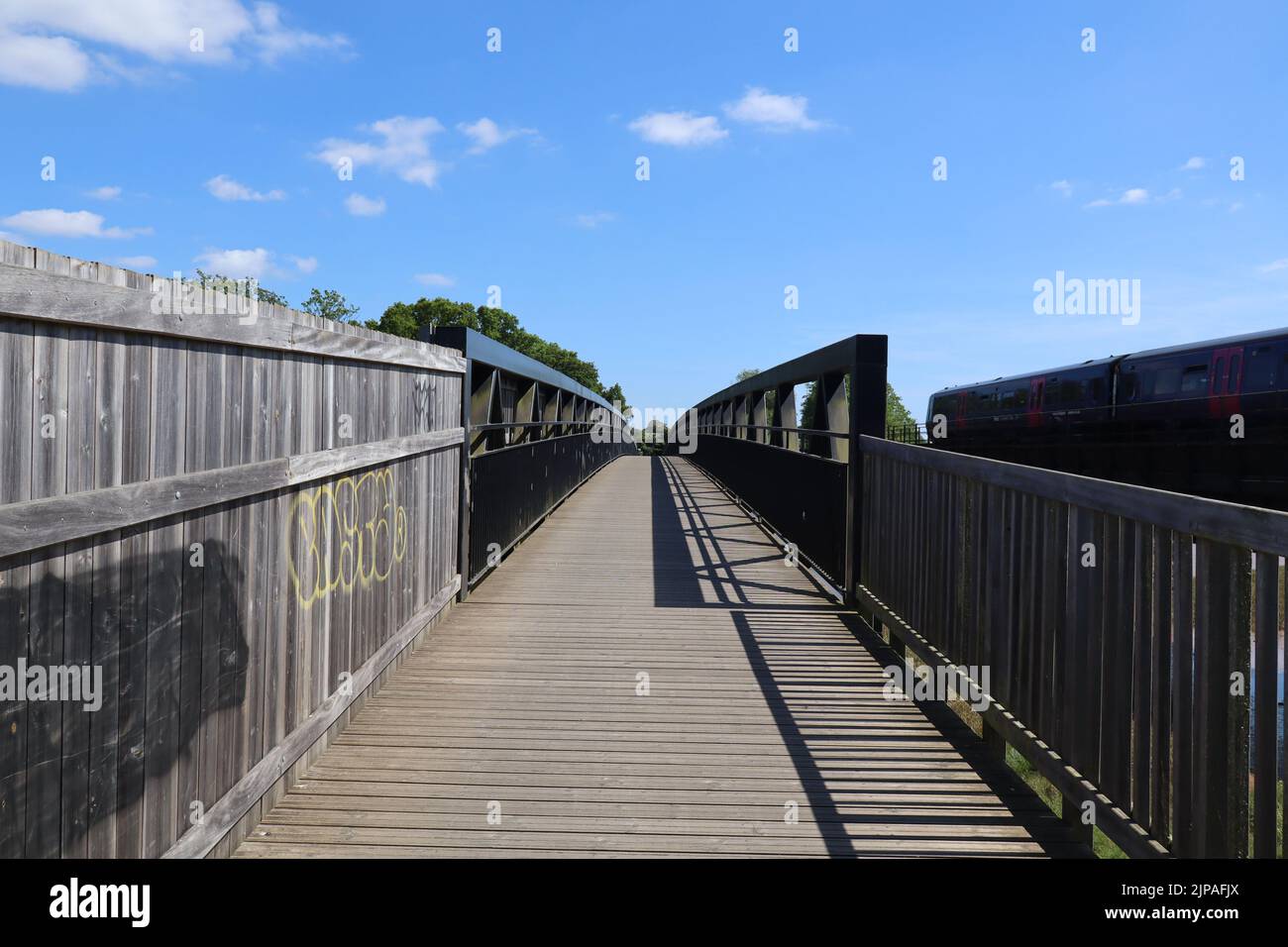 A metal bridge running over the bird sanctuary on the River Exe near Topsham in Devon, England Stock Photo