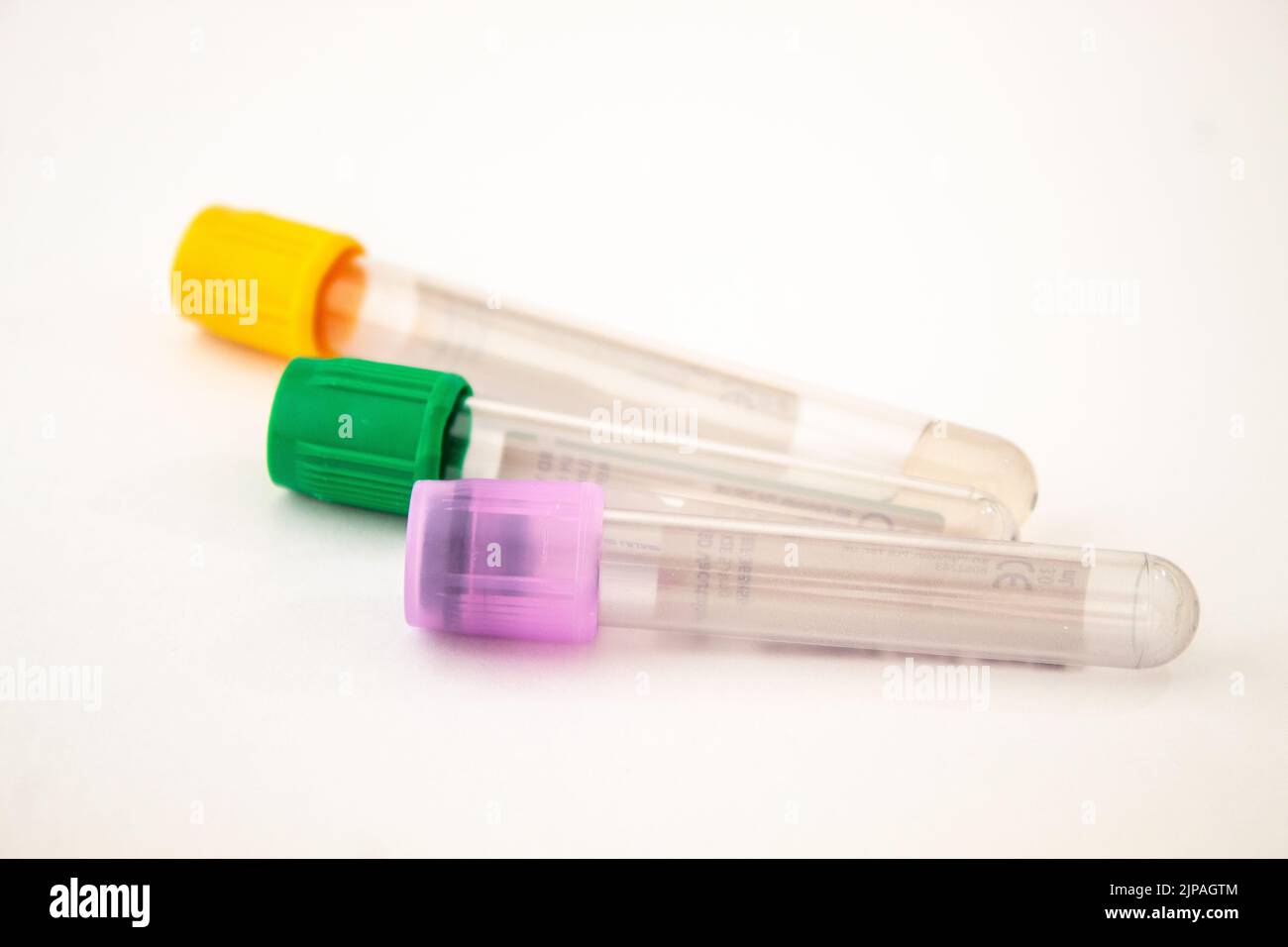 Yellow, green, purple colored blood test tubes on the isolated white