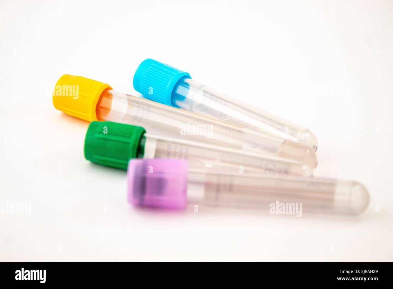 Yellow, green, purple, blue colored blood test tubes on the isolated