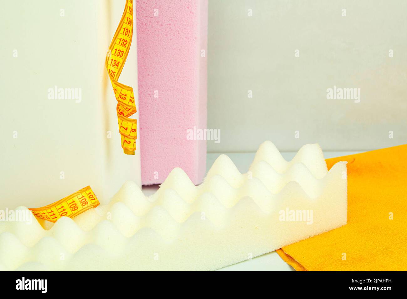 a piece of foam rubber of different sizes and colors, production of upholstered furniture Stock