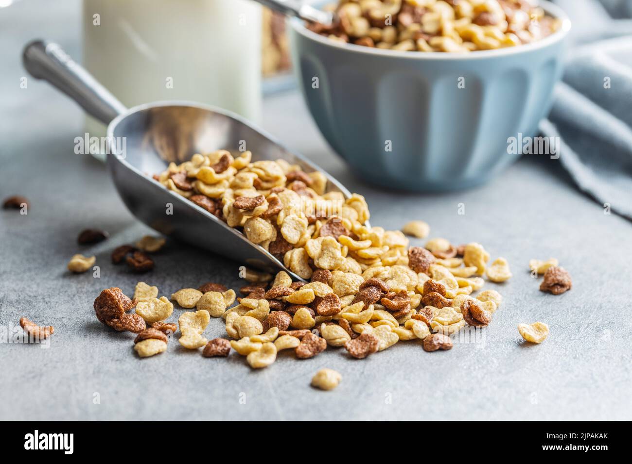 Breakfast cereal flakes in scoop on a kitchen table. Stock Photo
