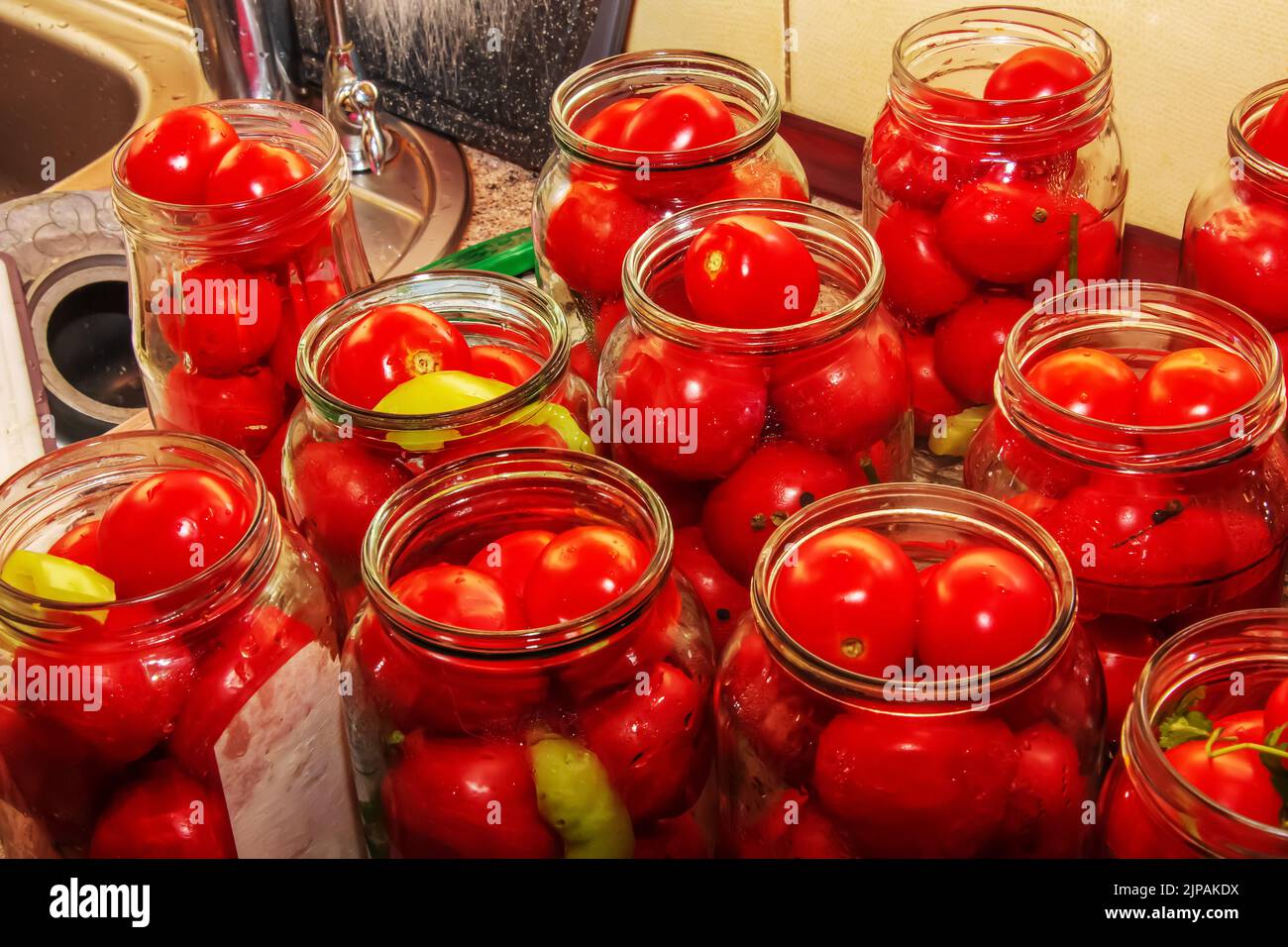 The process of preserving tomatoes for the winter. Ripe red juicy