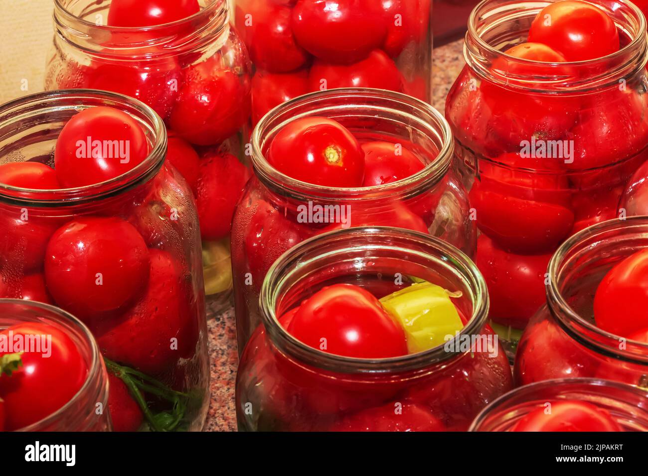 The process of preserving tomatoes for the winter. Ripe red juicy
