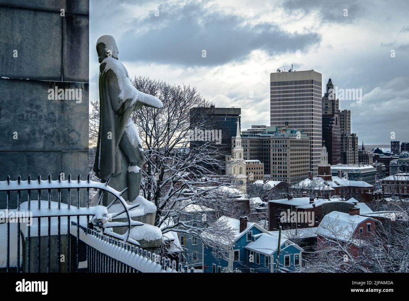 The statue of Roger Williams facing urban scenery of modern buildings,  Prospect Terrace, Providence, Rhode Island Stock Photo