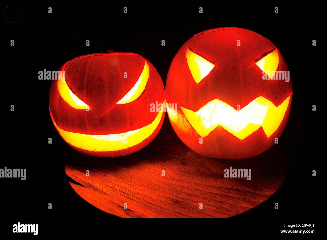 closeup of scary halloween pumpkins on black dark background Stock Photo