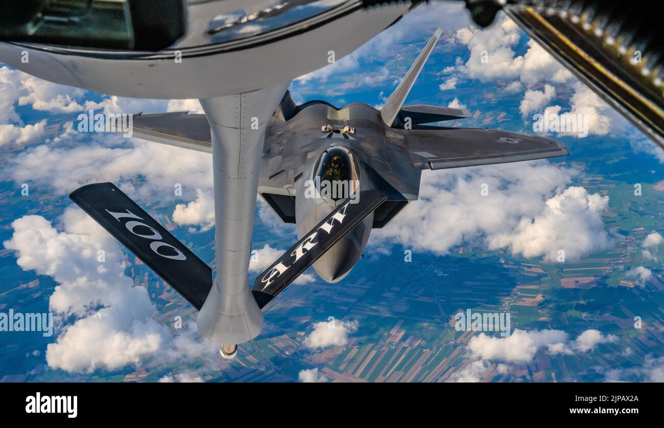 Lask, Poland. 10 August, 2022. A U.S. Air Force F-22 Raptor fighter jet, assigned to the 90th Fighter Squadron, approaches a  KC-135 Stratotanker refueling aircraft during a NATO Air Shielding mission, August 10, 2022 over Lask, Poland.   Credit: SSgt. Kevin Long/U.S. Air Force/Alamy Live News Stock Photo