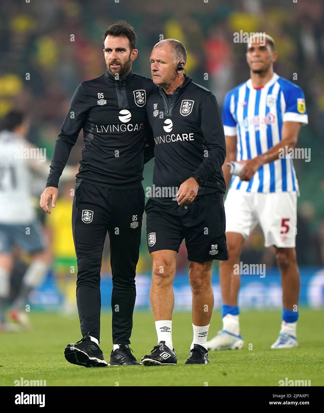 Huddersfield Town manager Danny Schofield (left) and sport therapist Dave Hallam after the final whistle in the Sky Bet Championship match at Carrow Road, Norwich. Picture date: Tuesday August 16, 2022. Stock Photo