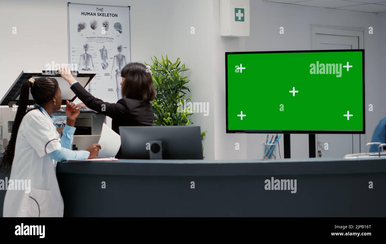 Waiting area and reception desk with greenscreen on tv display