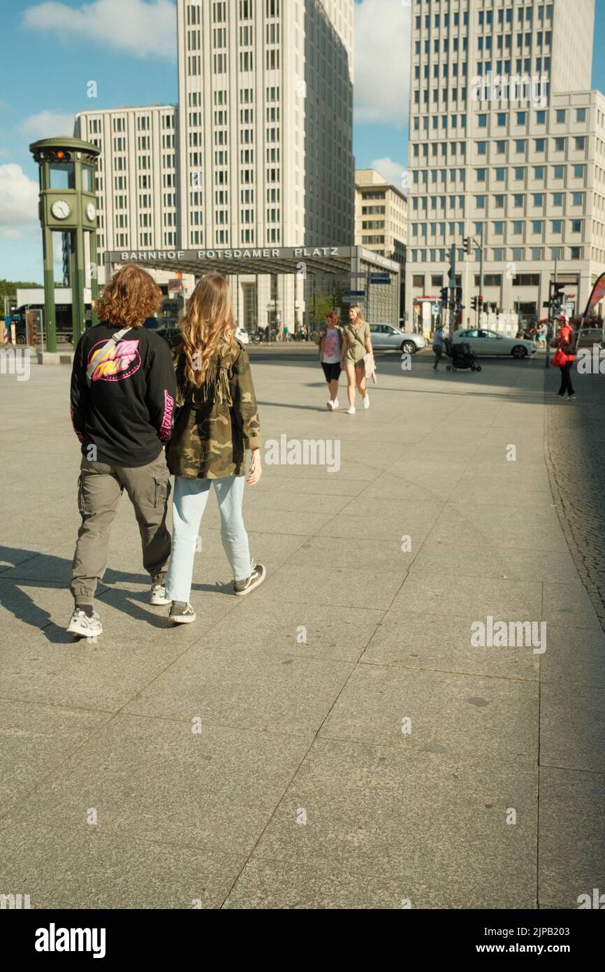 The two teenage hipsters walking across Potsdamer Platz in Berlin, Germany Stock Photo