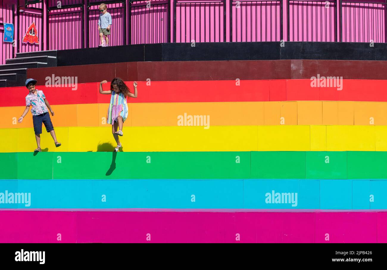 Somerset House, Summer 2022; a celebratory exhibition, The Bright Land, created by Gareth Pugh and Carson McCall. Children playing on rainbow steps. Stock Photo