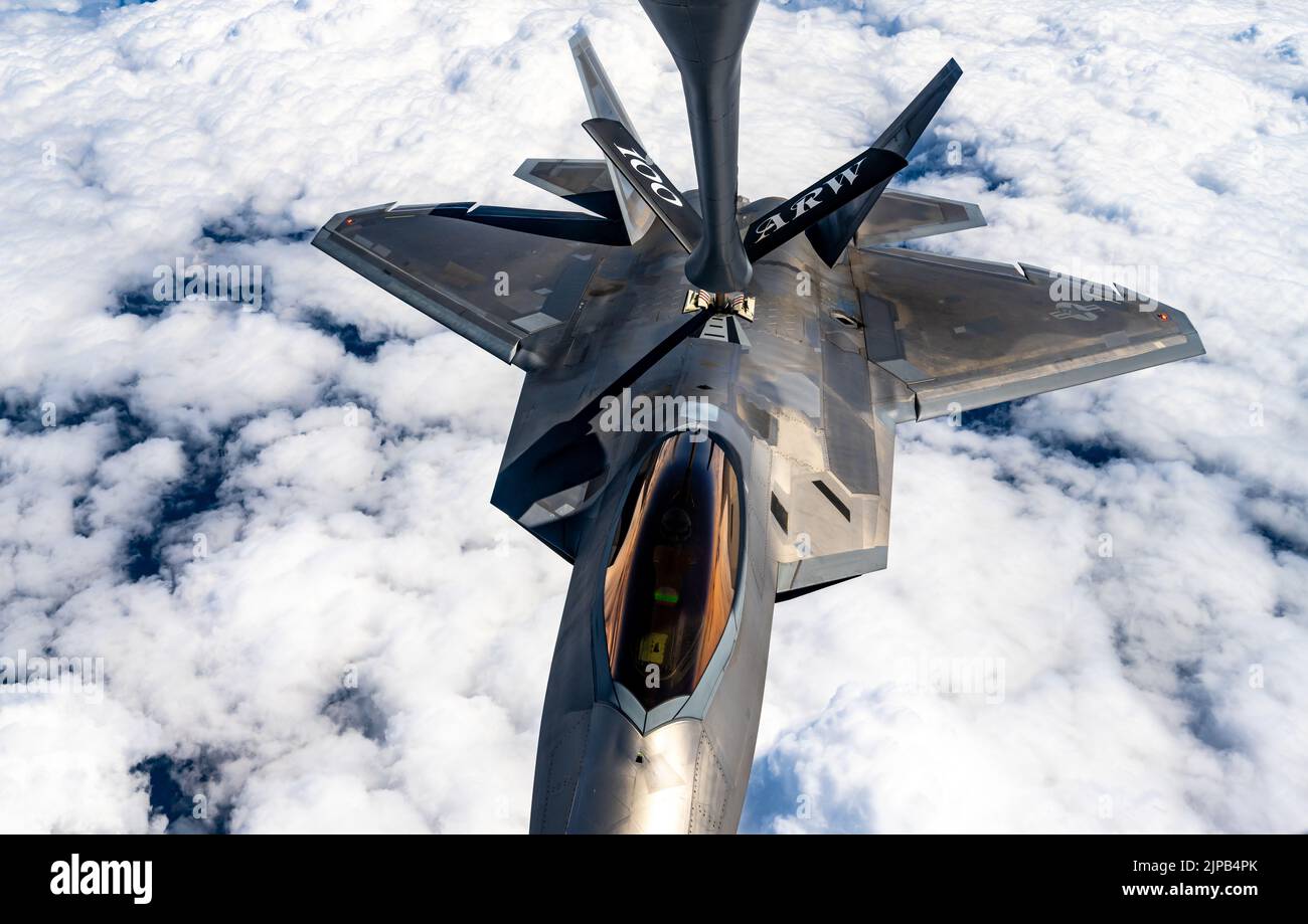A U.S. Air Force KC-135 Stratotanker aircraft assigned to the 100th Air Refueling Wing, Royal Air Force Mildenhall, England refuels a U.S. Air Force F-22 Raptor aircraft assigned to the 90th Fighter Squadron, Joint Base Elmendorf-Richardson, Alaska, over Poland, Aug. 10, 2022. The 100th ARW provides the critical air refueling bridge that enables strategic assets to operate in forward locations, and postures NATO forces to extend global reach and amplify operational capability throughout Europe. (U.S. Air Force photo by Staff Sgt. Kevin Long) Stock Photo