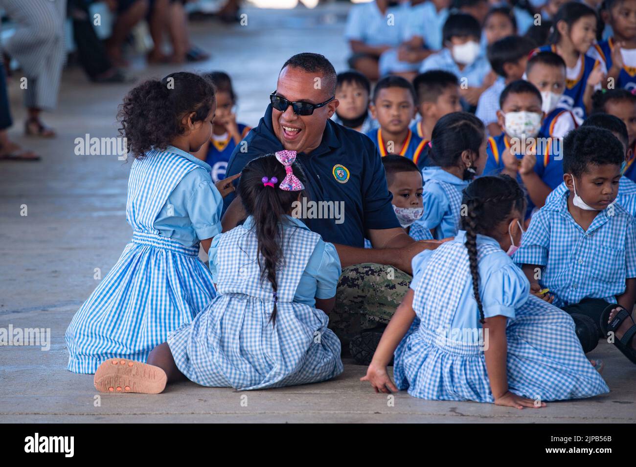 Palau. 19th July, 2022. Musician 2nd Class Omar Machado, from Barceloneta, Puerto Rico, a member of the U.S. Pacific Fleet Band, interacts with children at a Pacific Partnership 2022 (PP22) host nation outreach event at the Koror Elementary School in Palau. Now in its 17th year, Pacific Partnership is the largest annual multinational humanitarian assistance and disaster relief preparedness mission conducted in the Indo-Pacific. Credit: U.S. Navy/ZUMA Press Wire Service/ZUMAPRESS.com/Alamy Live News Stock Photo