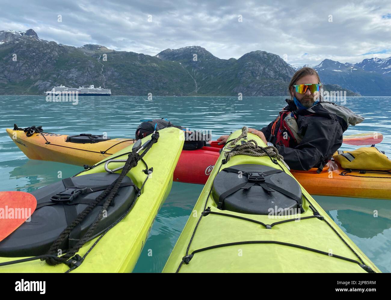 Glacier Bay, Alaska, USA. 3rd Aug, 2022. An expert guide prepares to take guests from the small Uncruise line Wilderness Discoverer kayaking in Glacier Bay National Park, Alaska, Wednesday August 3, 2022. A large cruise ship is in the background. (Credit Image: © Mark Hertzberg/ZUMA Press Wire) Stock Photo