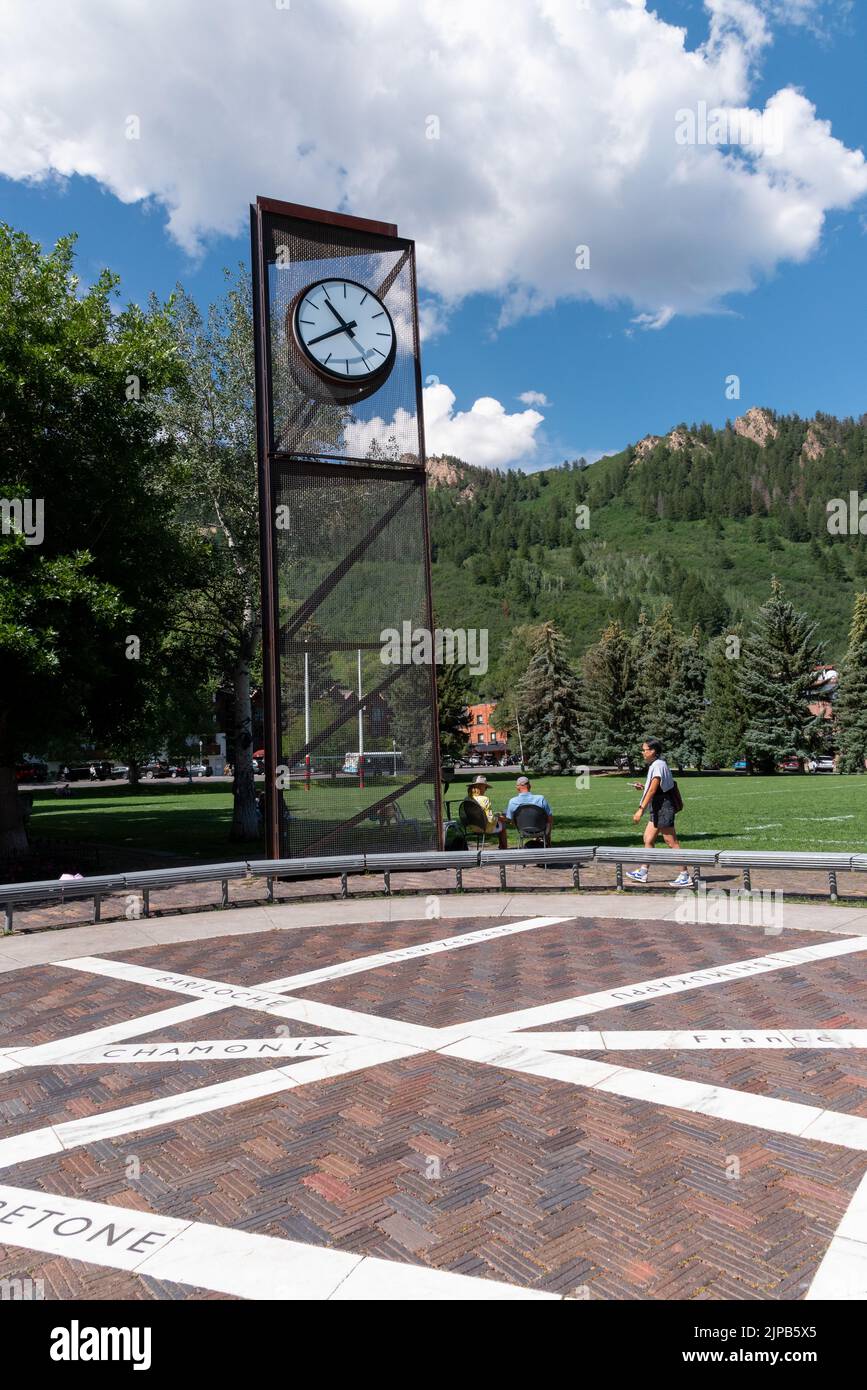 Tall clock tower in Wagner Park in Aspen, Pitkin County, Colorado. The time on the turret clock is 10:40. In the foreground is Sister Cities Plaza. Stock Photo
