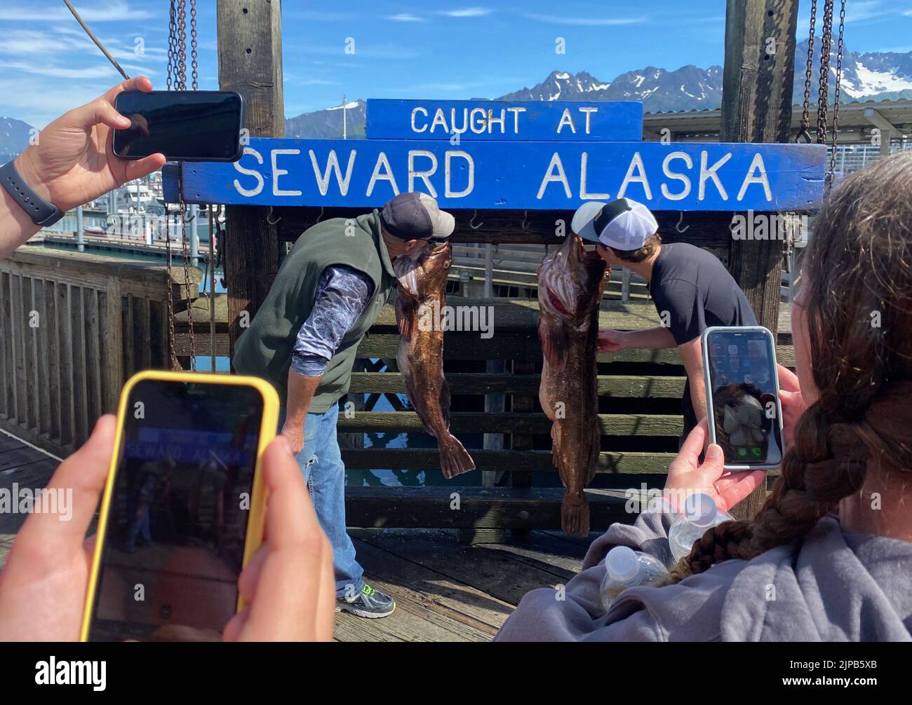 Seward, Alaska, USA. 29th July, 2022. Fishermen are photographed with their catch by friends and family members in port in Seward, Alaska Friday July 29, 2022. (Credit Image: © Mark Hertzberg/ZUMA Press Wire) Stock Photo