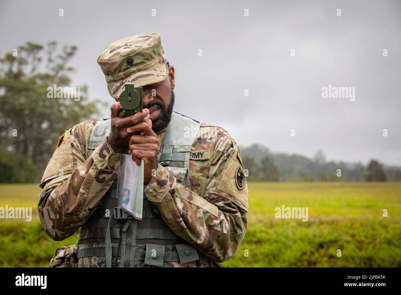 July 18, 2022 - Hawaii, USA - Spc. Marcus Grant assigned to U.S. Army Japan looks through his compass July 18 at Lightning Academy, Hawaii during the land navigation for the 2022 U.S. Army Pacific Best Squad Competition. The 2022 U.S. Army Pacific Best Squad Competition consists of multiple 5-Soldier squads from USARPAC units competing for the opportunity to represent USARPAC at the Department of the Armys competition. stations. The non-commissioned officers and junior enlisted will be assessed together in their ability to execute warrior tasks and battle drills, marksmanship and land navigati Stock Photo