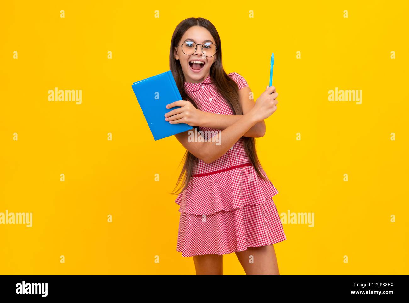 Amazed teen girl. Teenager school girl study with books. Learning knowledge and kids education concept. Excited expression, cheerful and glad. Stock Photo