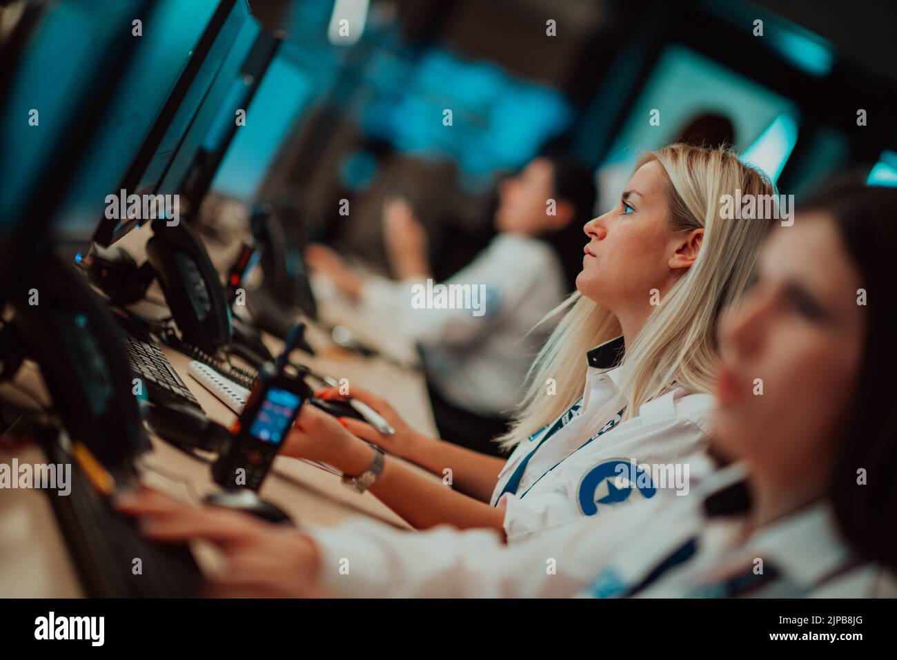 Female security operator working in a data system control room offices