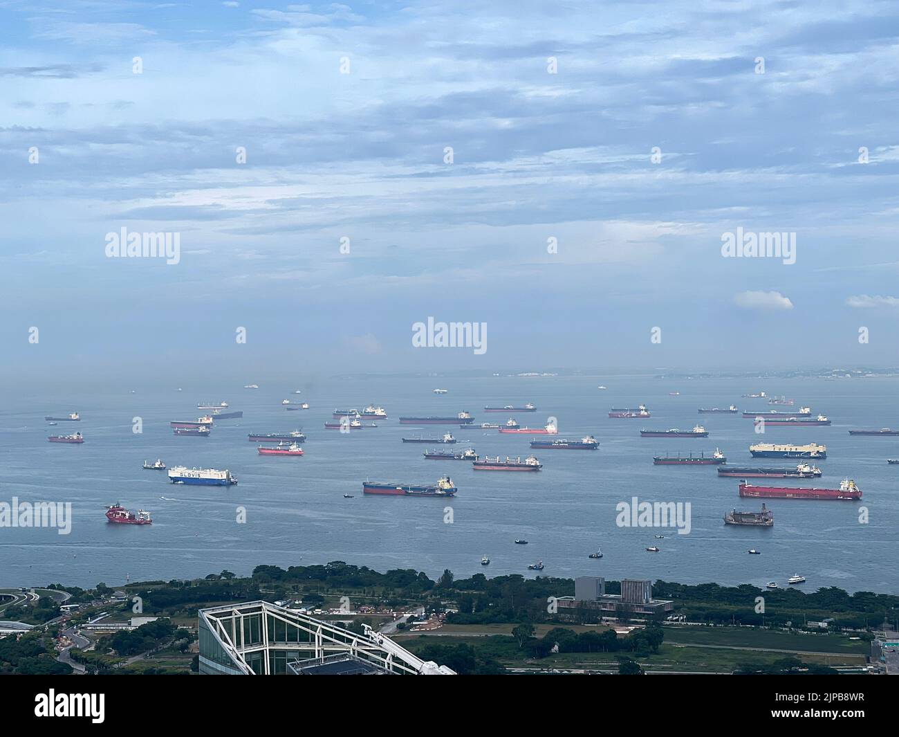 An aerial view of ships and the coast of the Singapore Strait Stock Photo