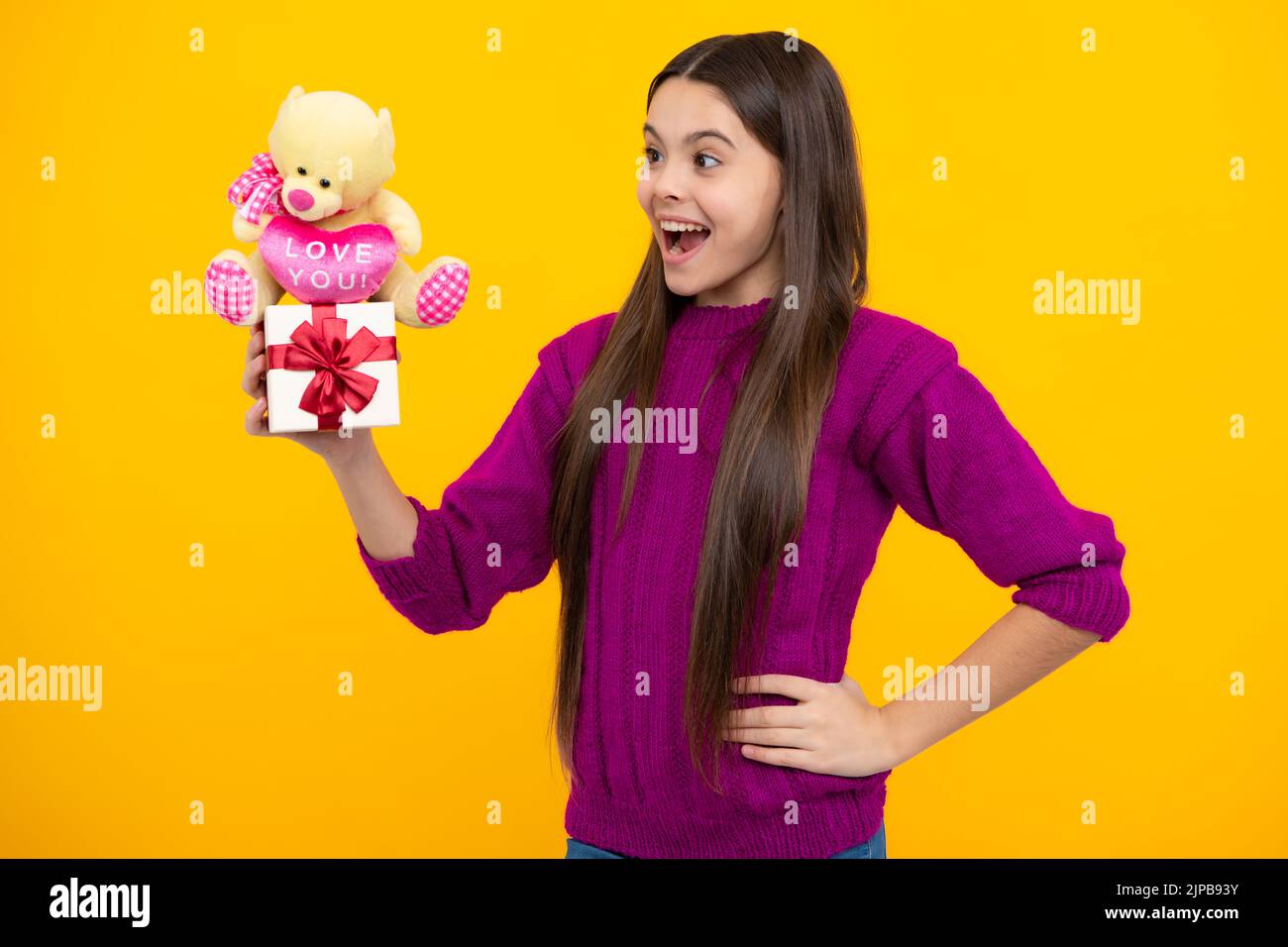Portrait of a teenager child girl holding present box isolated over ...