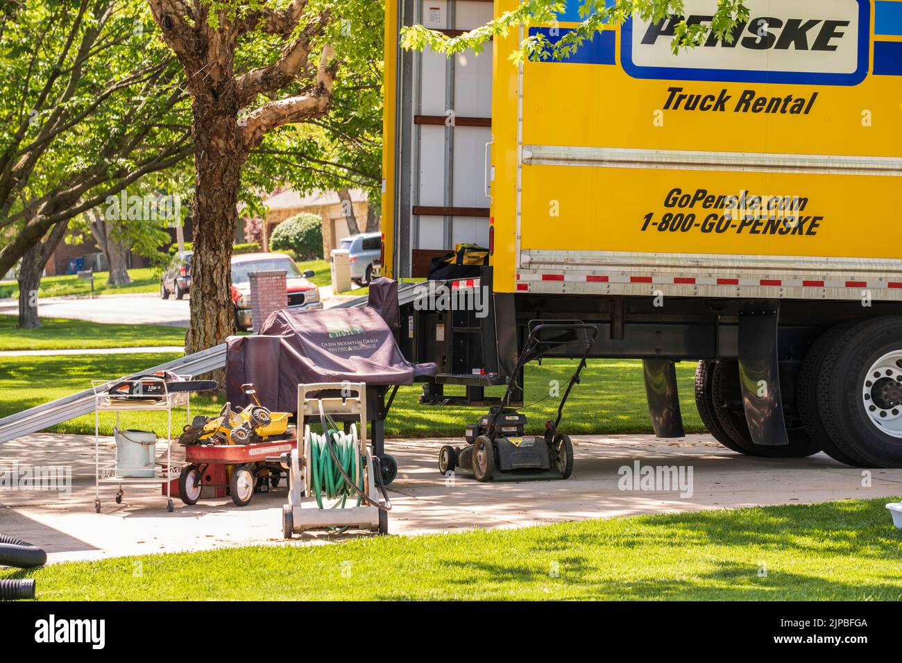 Penske moving truck being loaded with household belongings in preparation to move to another house. Kansas, USA. Stock Photo