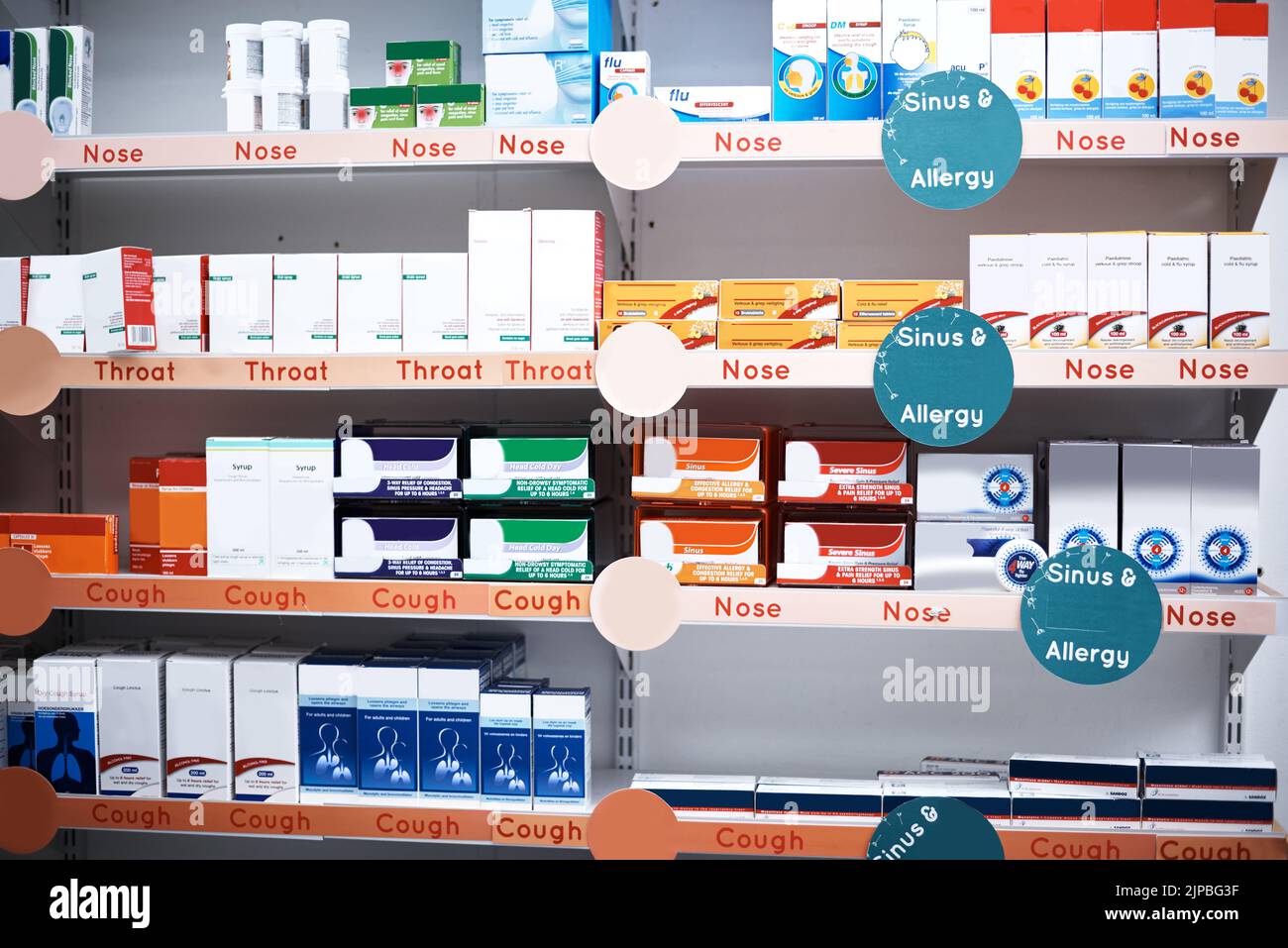 Weve got a broad range on offer. shelves stocked with various medicinal products in a pharmacy. Stock Photo