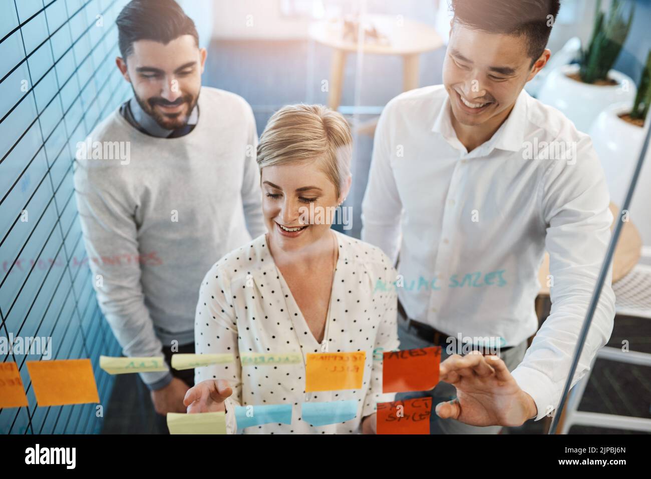 Theyre making progress. three young businesspeople brainstorming with ...