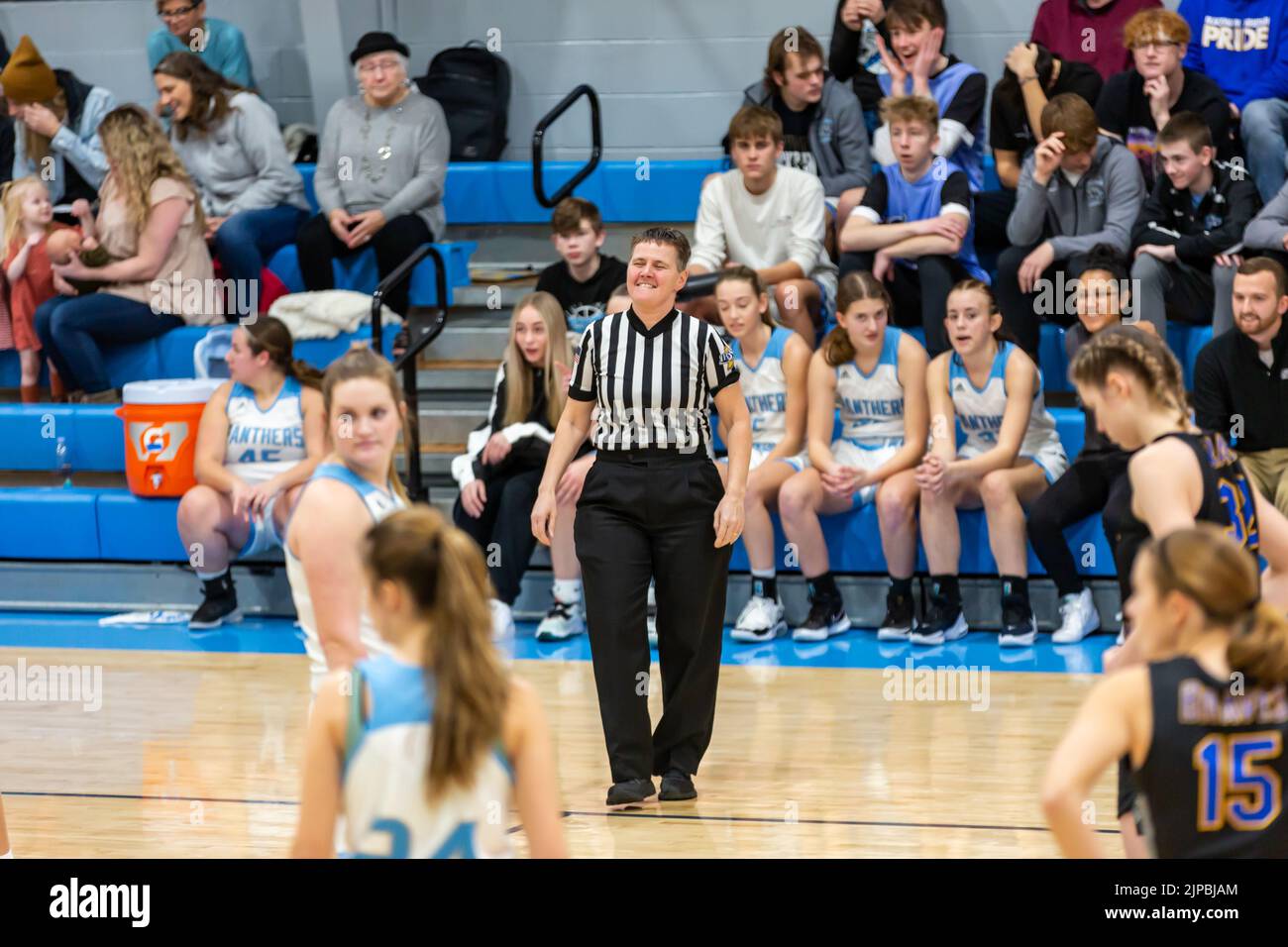 A female IHSAA referee officiates a girls' high school basketball game