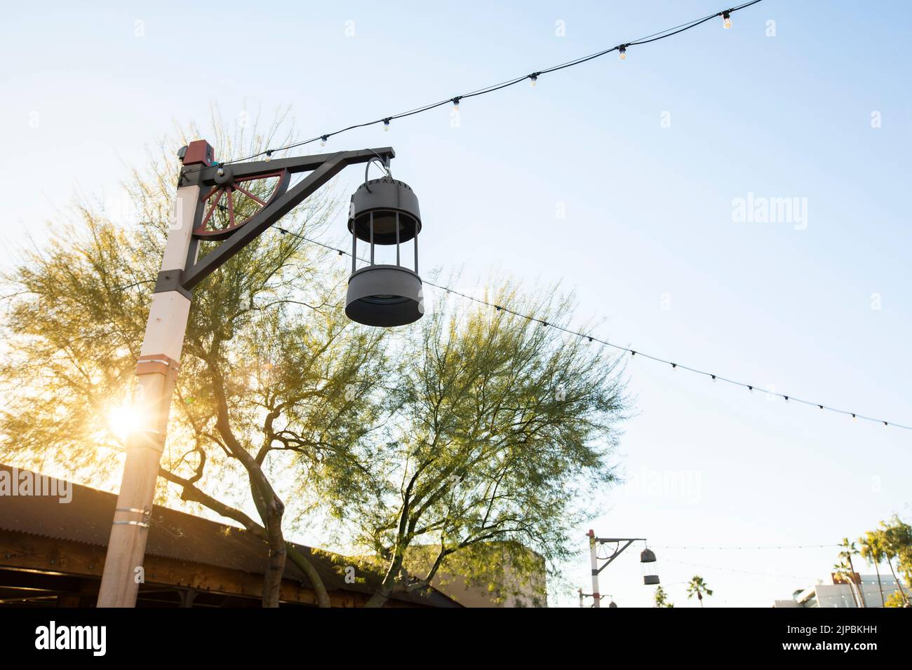Late afternoon view of a light post framing the historic Old Town of