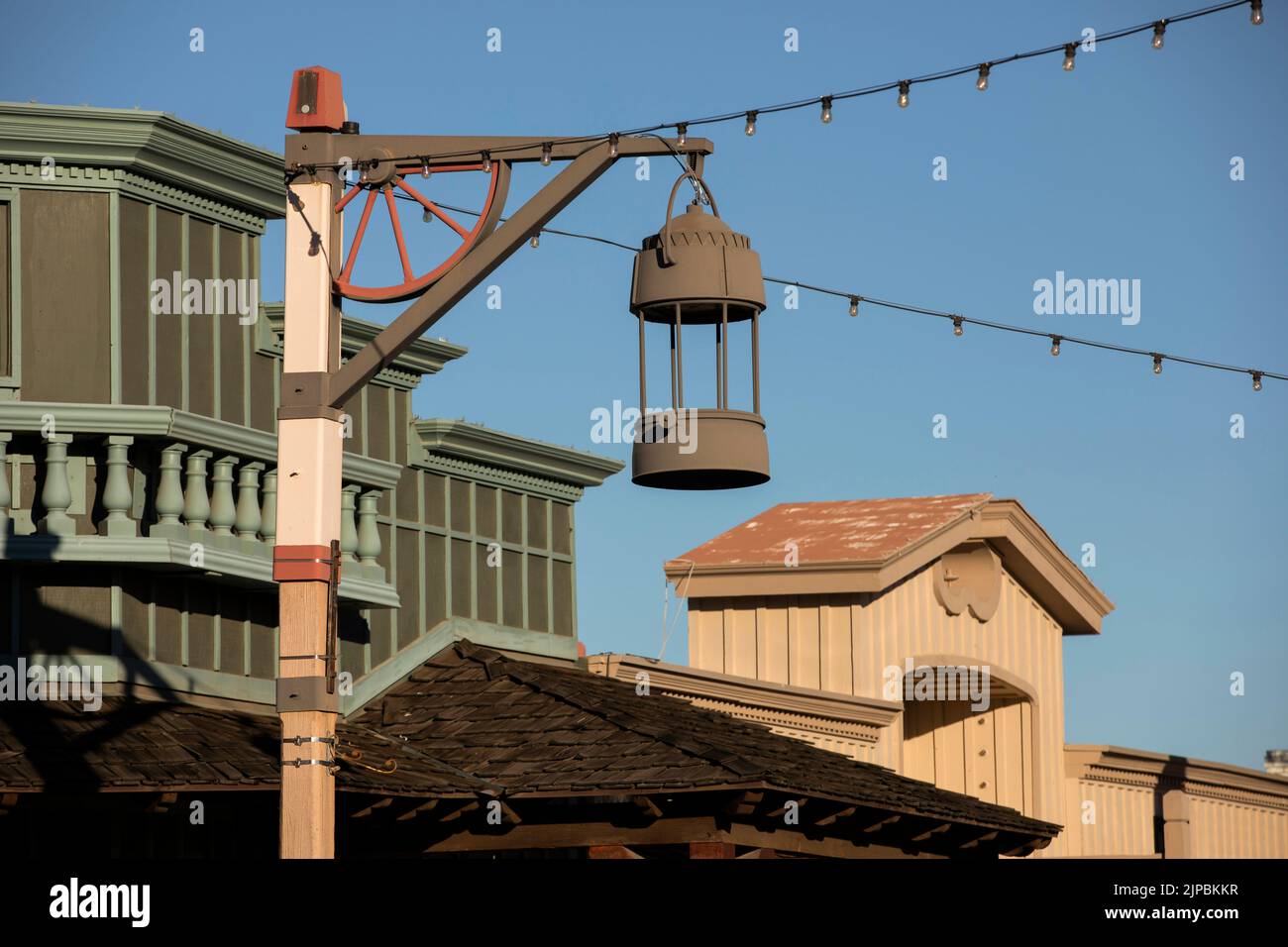 Late afternoon view of a light post framing the historic Old Town of