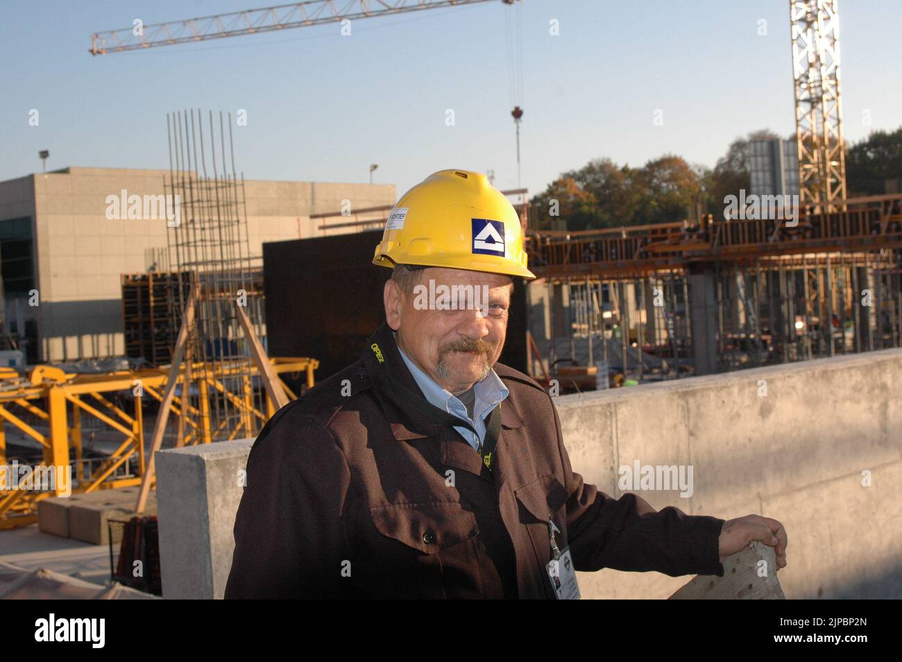 Polish construction worker male and construction work site inPoznan