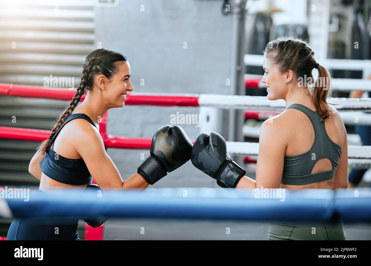 Boxing women, healthy and athletic sparring indoors. Beautiful sporty girls keep active with friendly competition through fitness and exercise. Happy Stock Photo