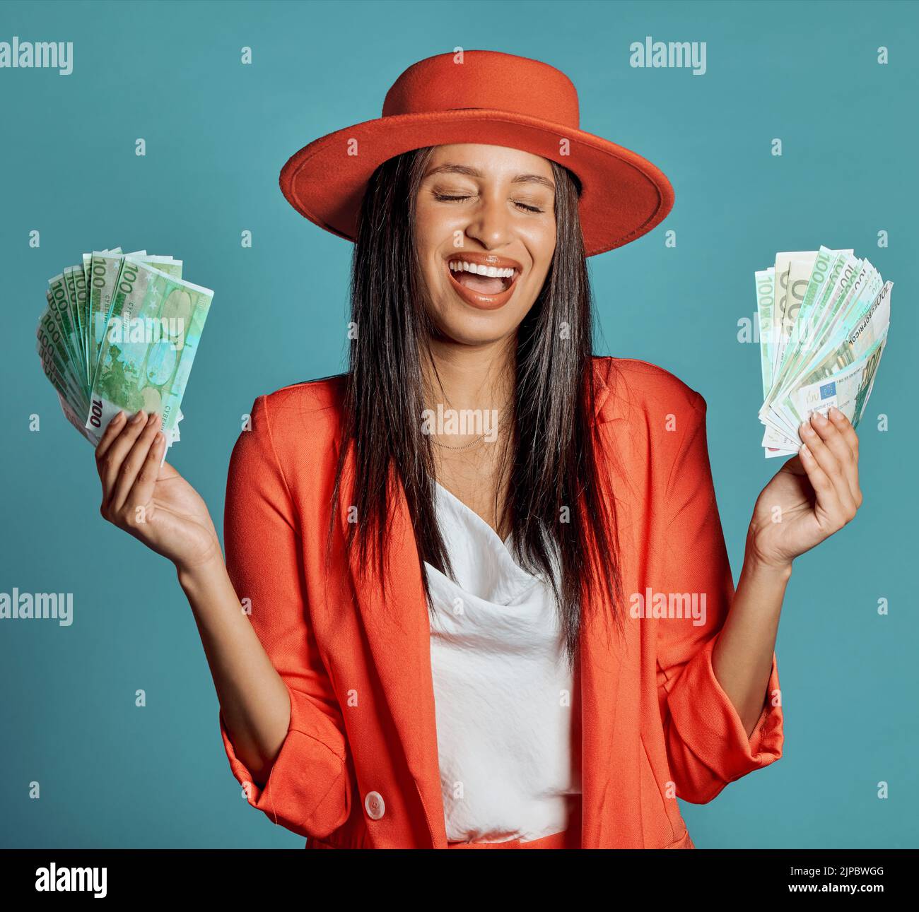 Money, currency and winning the lottery with a young woman holding cash and looking happy, excited and celebrating success. Female cheering with Stock Photo