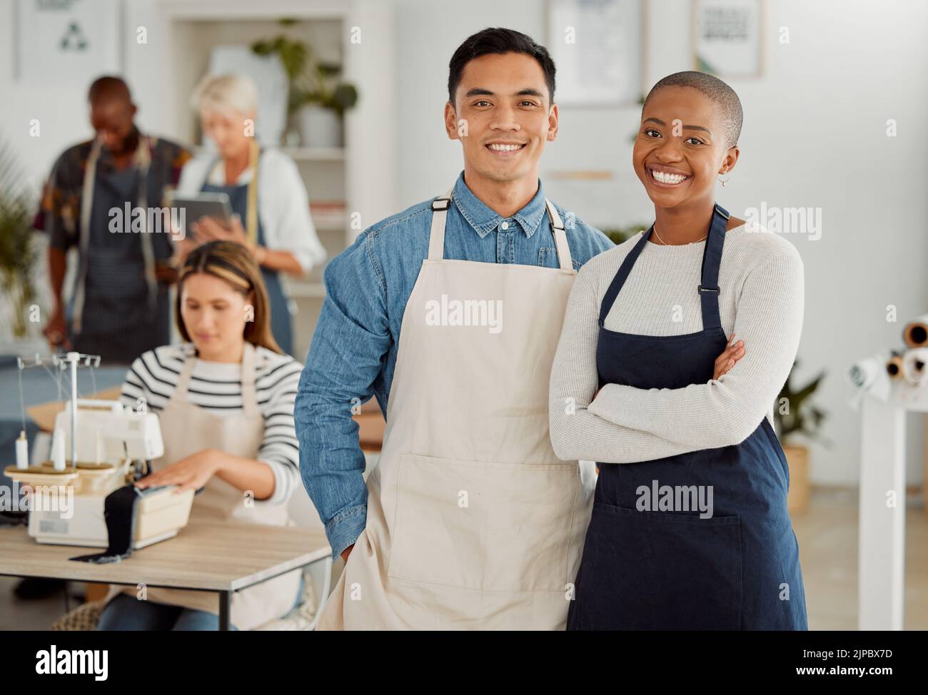 Proud fashion designers, colleagues and creatives smiling while making trendy clothes for fashion in a studio. Portrait of happy team managers in Stock Photo