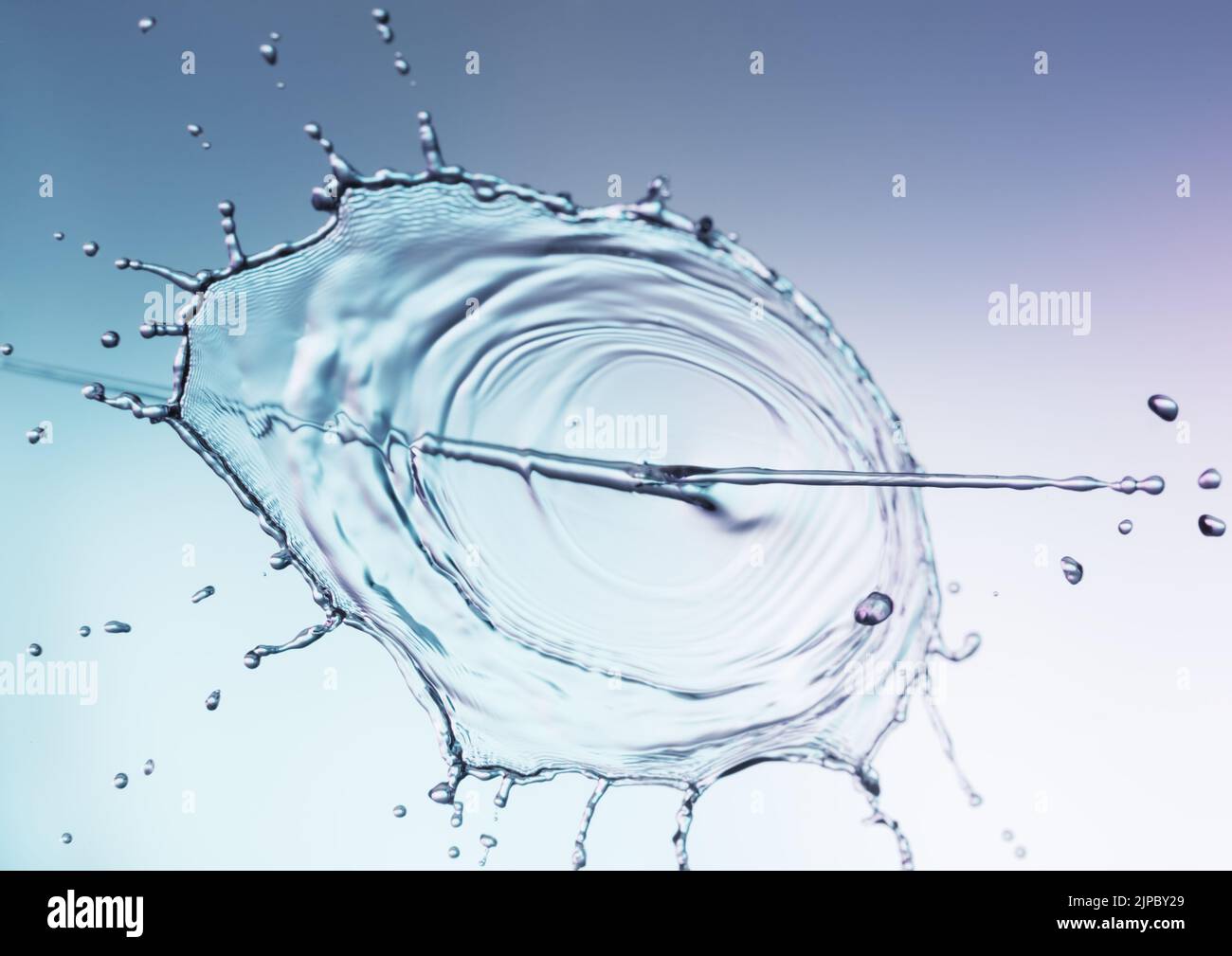 Clear water liquid splash on a blue background Stock Photo