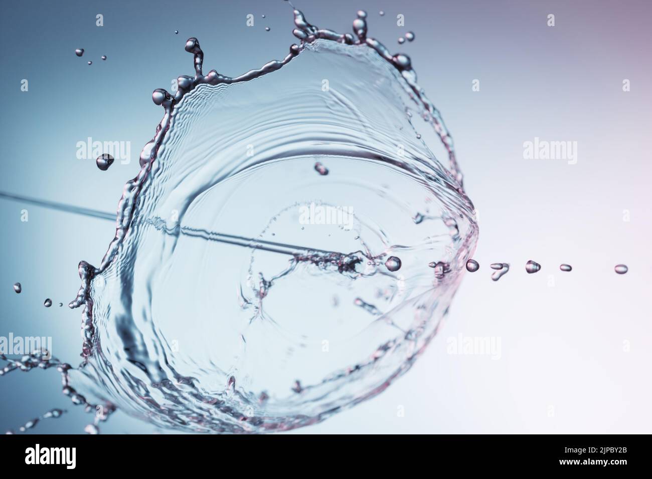 Clear water liquid splash on a blue background Stock Photo