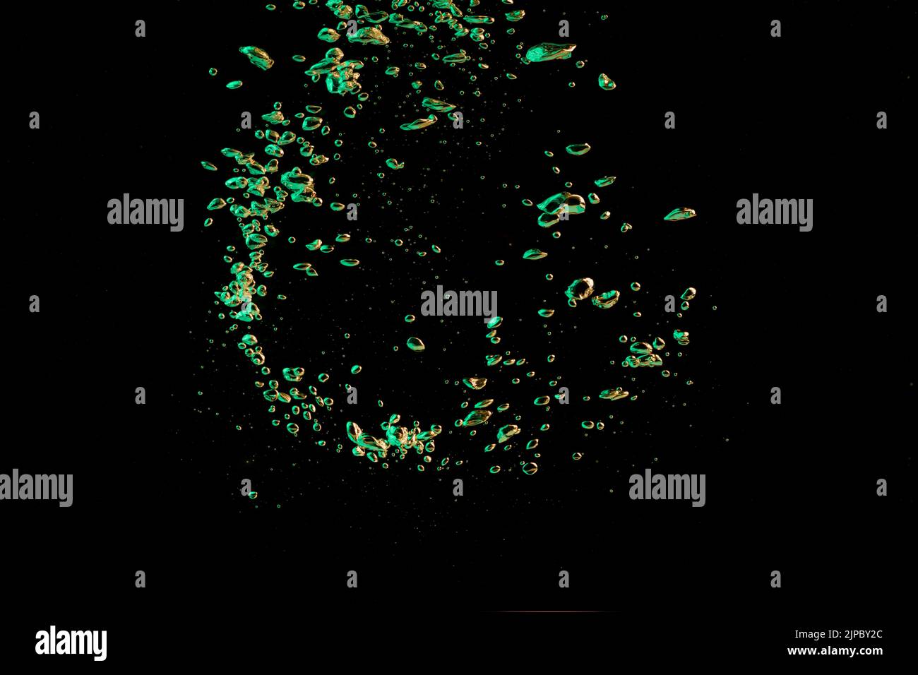 A bubble splash in transparent clear water liquid in green and yellow light on a black nature background Stock Photo