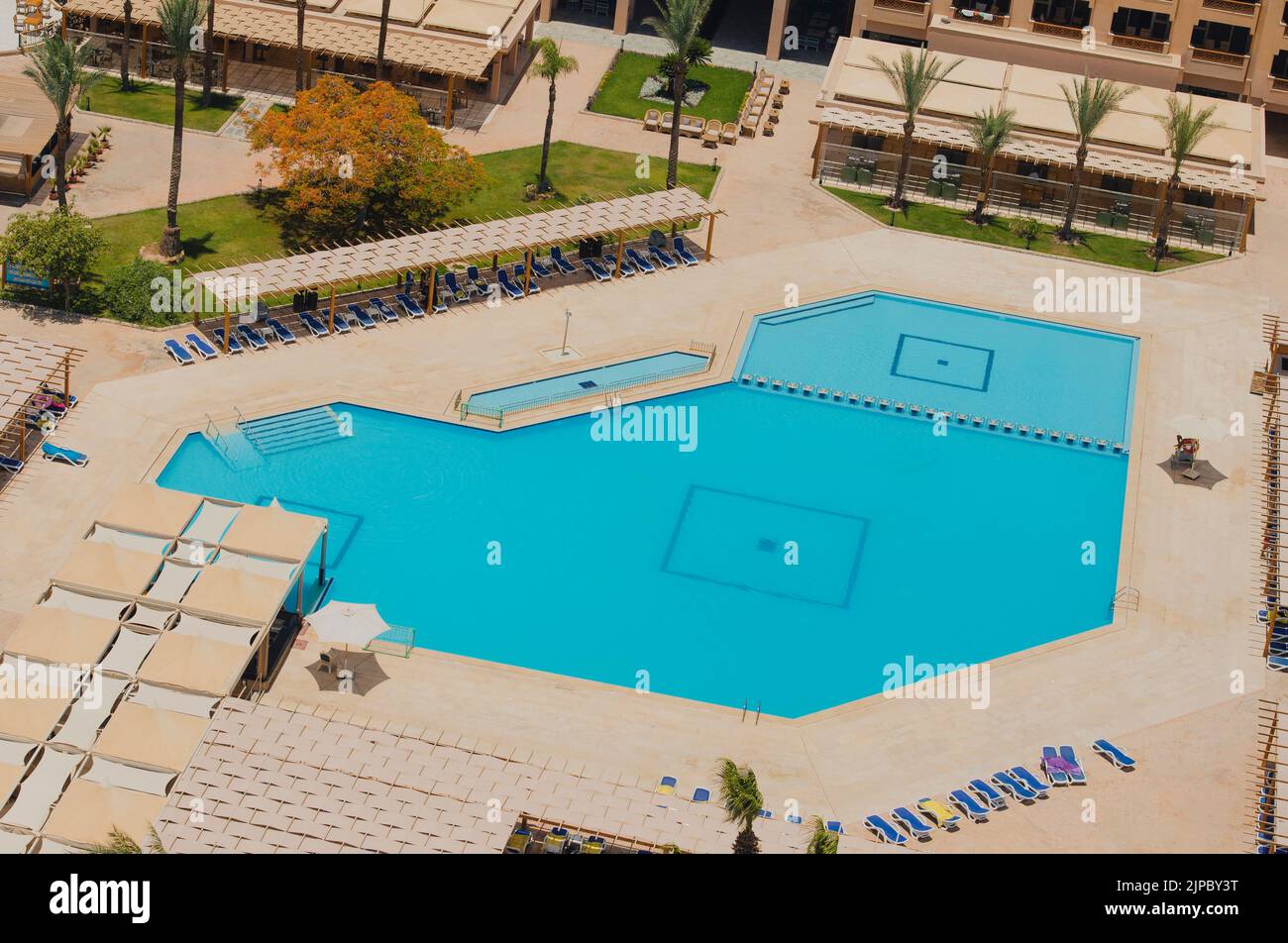 Aerial view of a large swimming pool in a luxury tropical hotel with ...