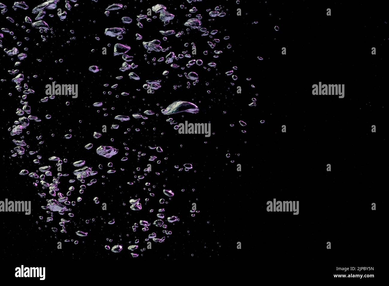 A bubble splash in transparent clear water liquid in purple and blue light on a black nature background Stock Photo