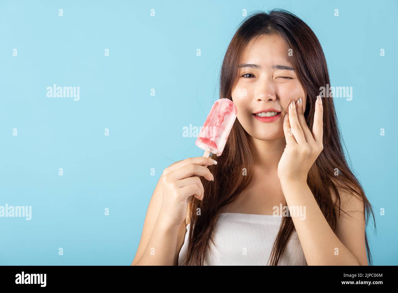 Portrait of Asian young woman with sensitive teeth after eating