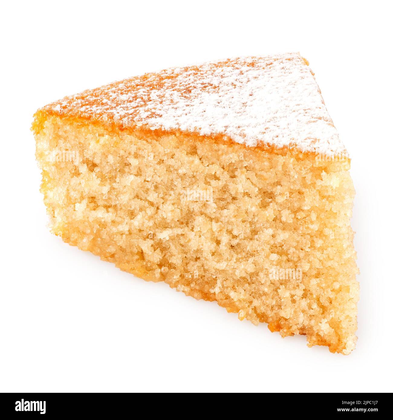 Wedge of lemon sponge cake with icing sugar topping isolated on white. Stock Photo