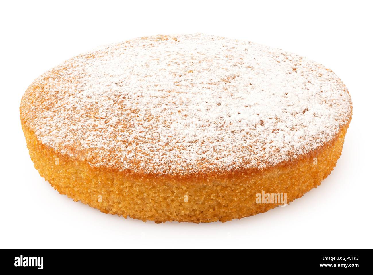 Whole lemon sponge cake with icing sugar topping isolated on white. Stock Photo