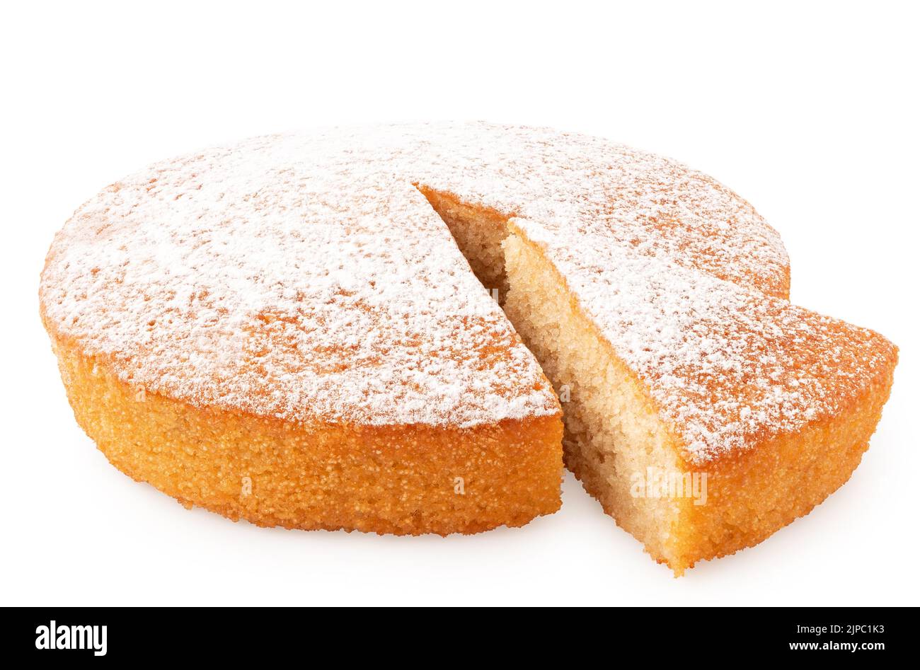 Whole lemon sponge cake with icing sugar topping and cut out wedge isolated on white. Stock Photo
