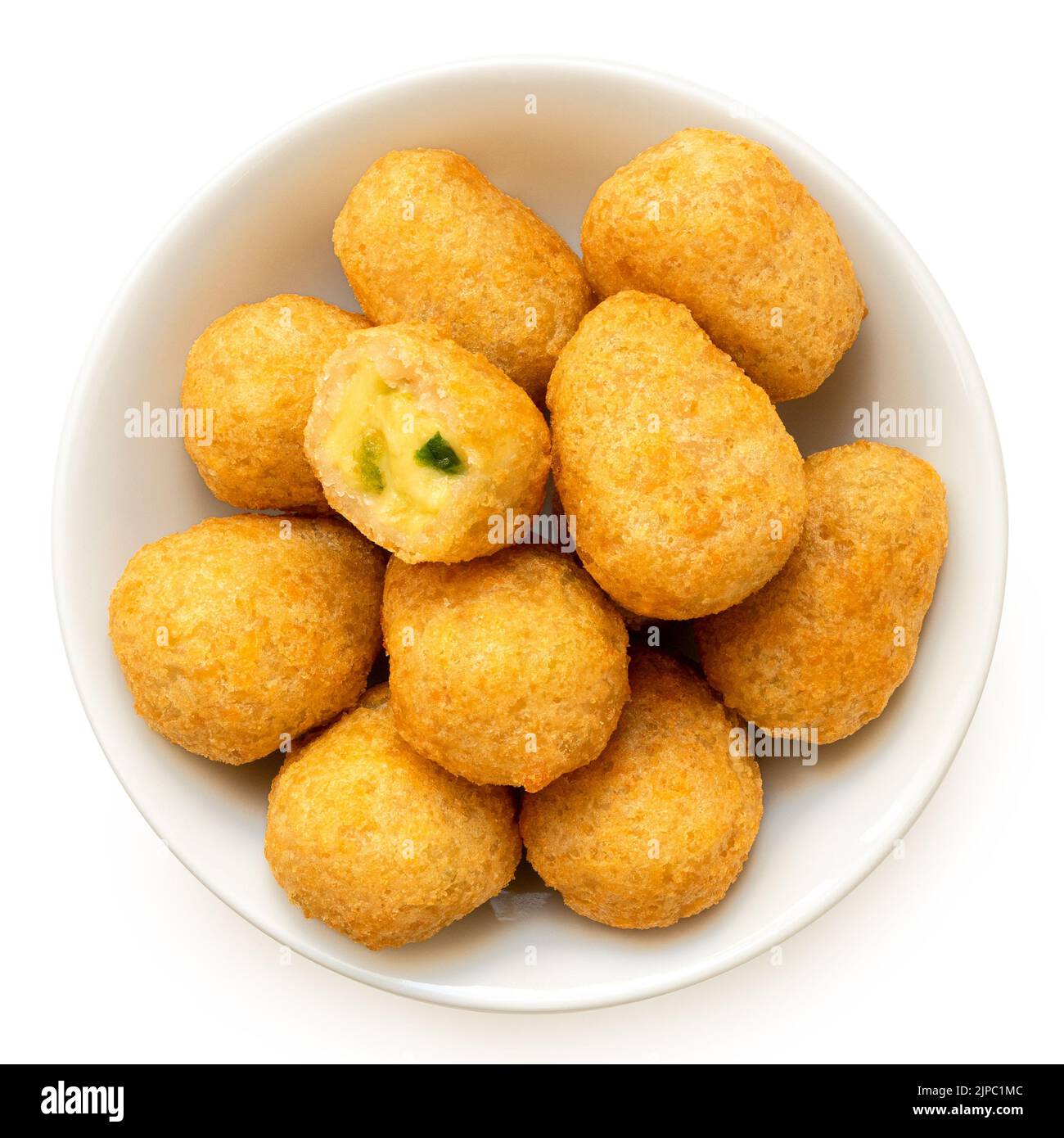 Fried breaded chilli cheese nuggets in a white ceramic bowl isolated on white. One eaten. Top view. Stock Photo