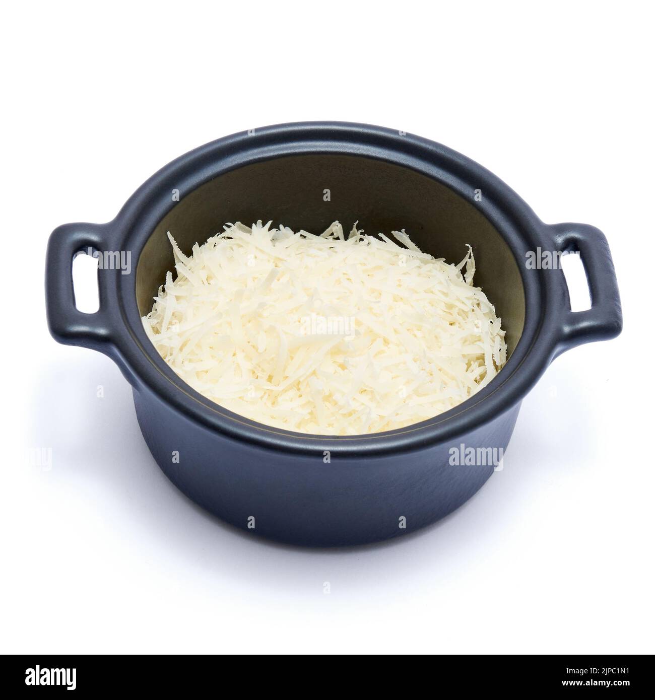 grated Parmesan cheese in black ceramic bowl isolated on white