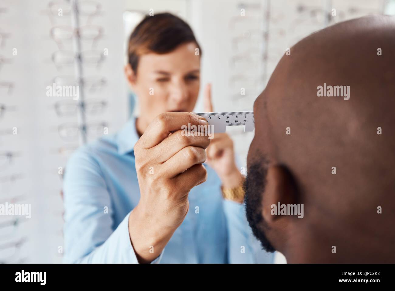 Optometrist, doctor and specialist checking vision retina measurement
