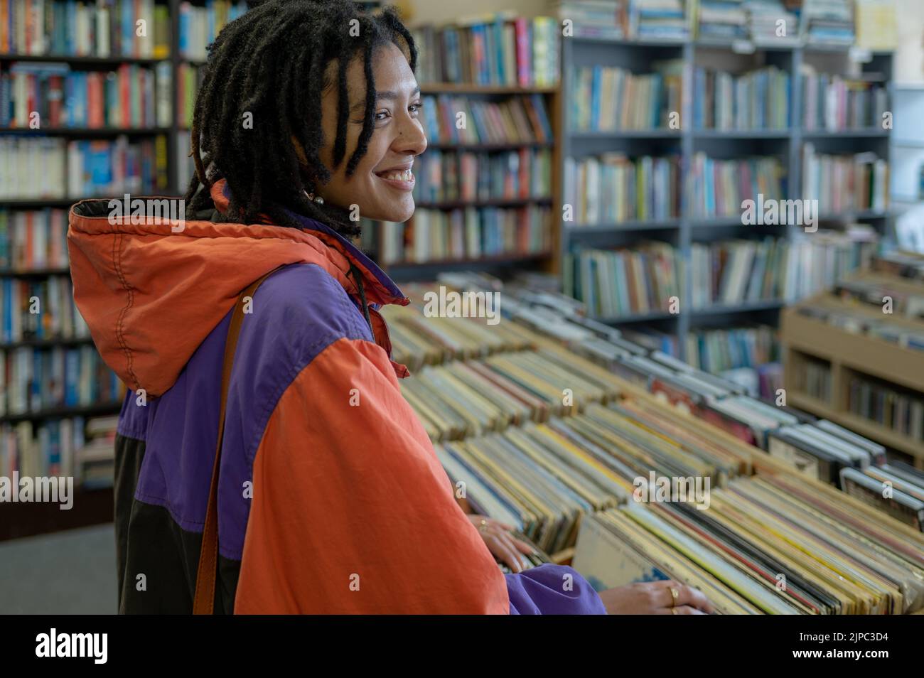 Woman seen searching through vinyl records Stock Photo