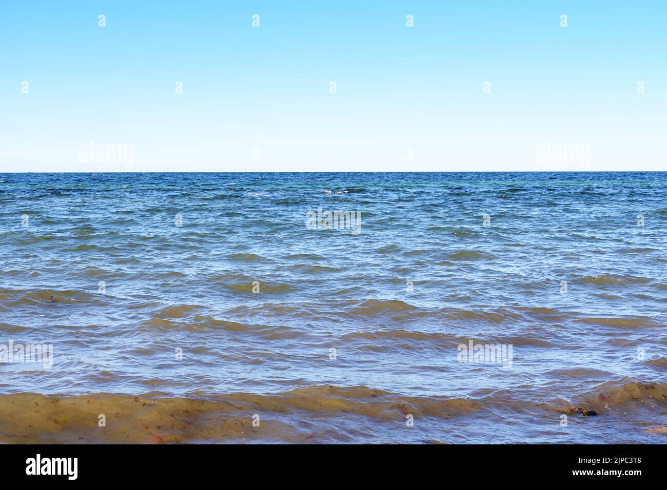 Small ocean waves on the sea, horizon and blue sky, nature and